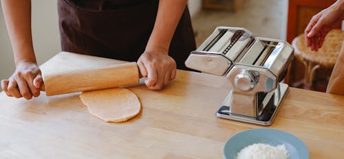 Free Person Kneading Dough with a Rolling Pin Stock Photo