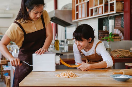 Women Using a Pasta Maker
