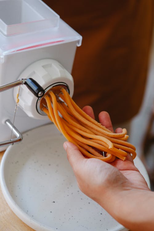 Close Up Shot of a Person Holding Noodles