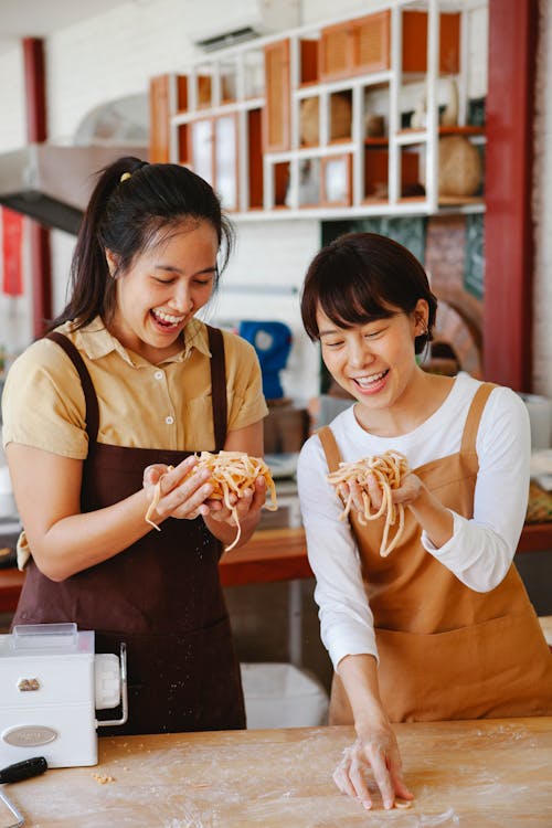 Women Holding Noodles