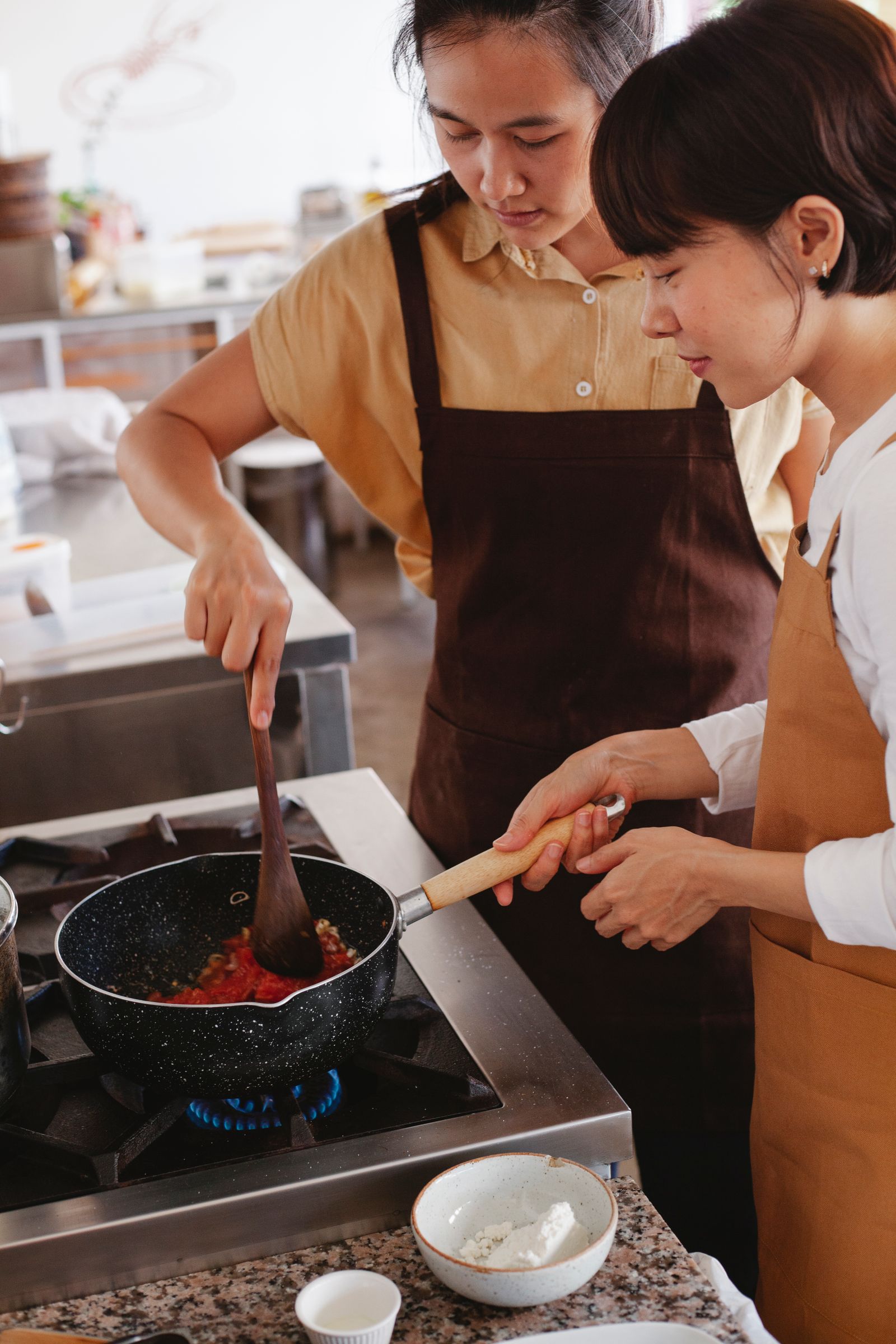 Two chefs cooking together in a modern kitchen