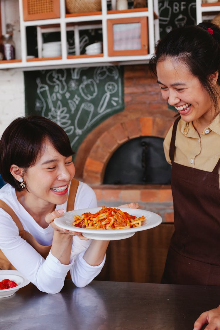 Woman Holding A Plate While Laughing