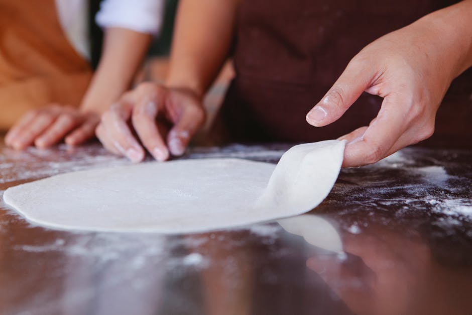 image of a pizzaiolo stretching dough by hand, highlighting the puffy edge - authentic neapolitan pizza image of a pizzaiolo stretching dough by hand, highlighting the puffy edge - authentic neapolitan pizza