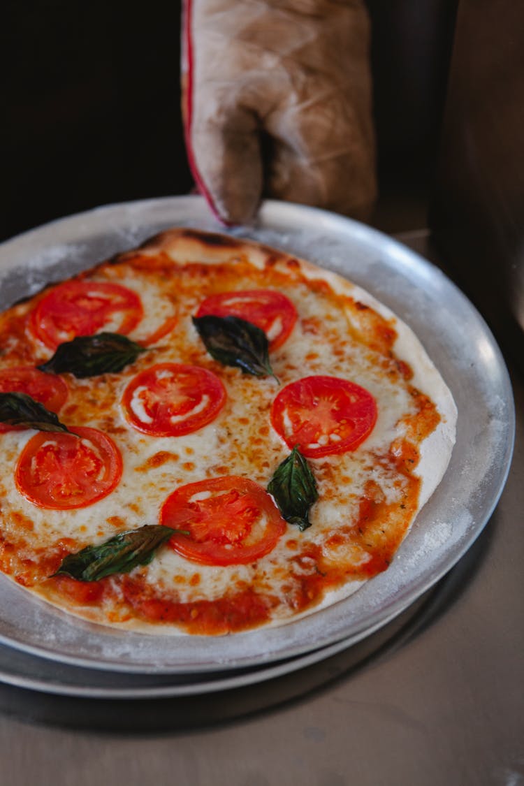 Tomato And Cheese Pizza On An Aluminum Plate