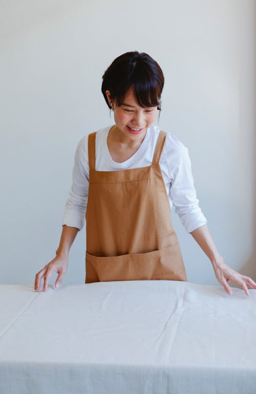 Woman with Short Hair Wearing Brown Apron