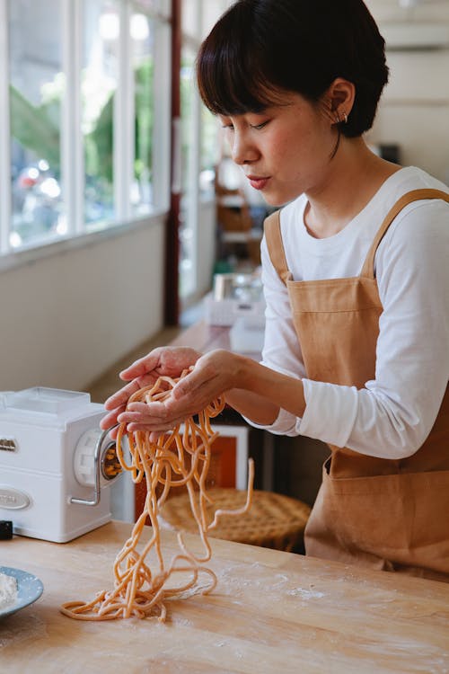 Woman with Short Hair Holding Noodles