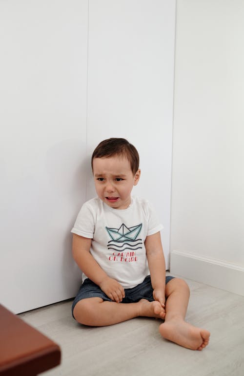 Free Kid Sitting on the Floor While Crying Stock Photo