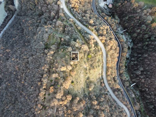 Aerial view of curvy road running through hilly terrain
