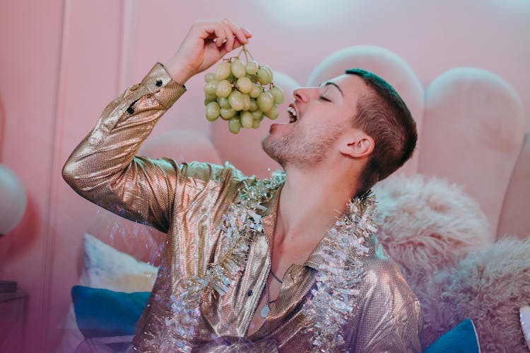 Close-Up Shot Of A Man Eating Grapes