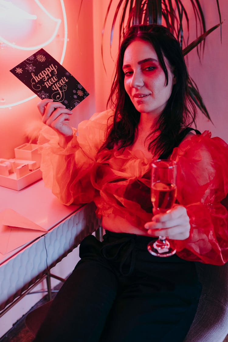 Woman Holding A Greeting Card And A Glass Of Wine