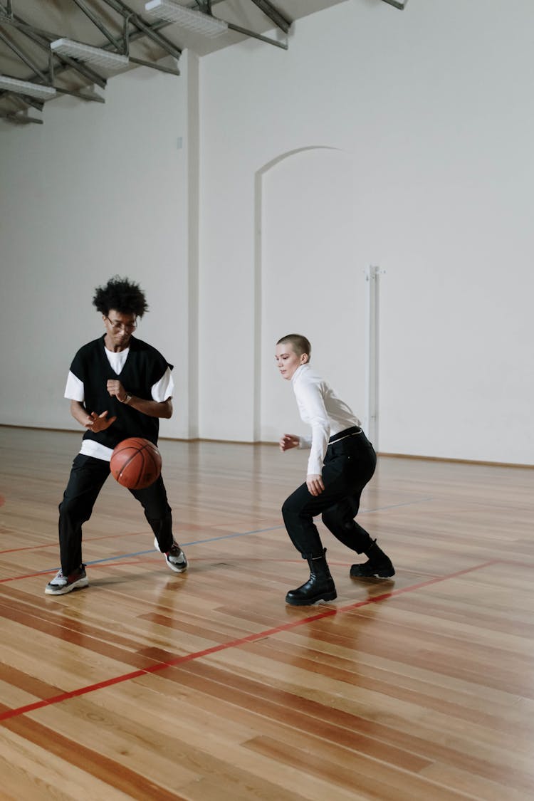 Schoolboys Playing Basketball In A School Gym 