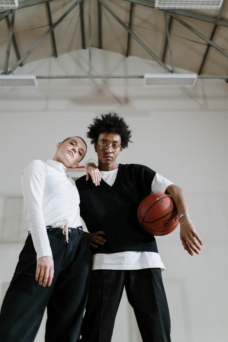 Man And Woman Posing With Basketball Ball