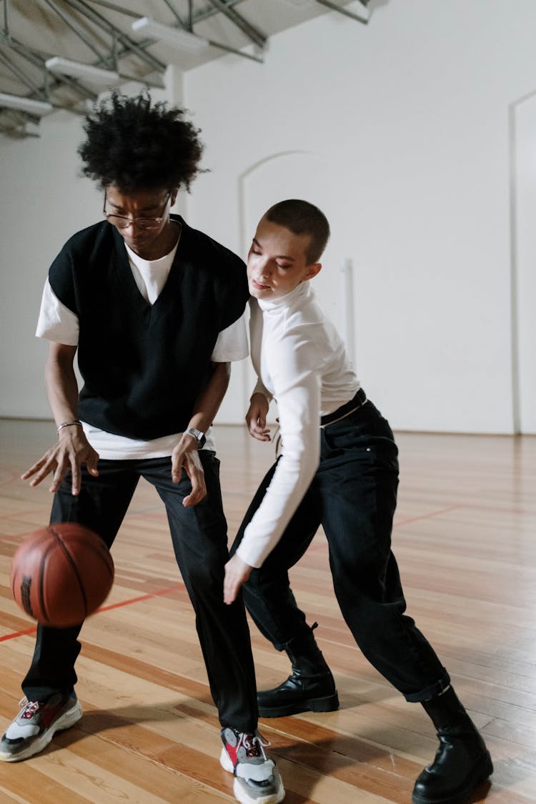Boys Playing Basketball In A School Gym 