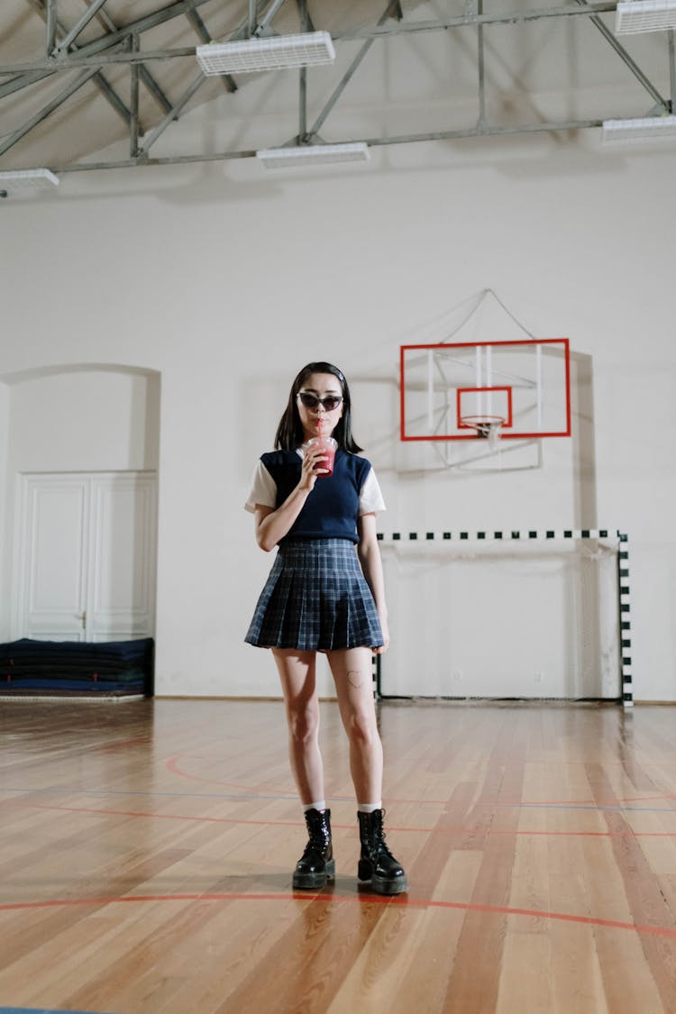 Schoolgirl Drinking Soda At School Gym