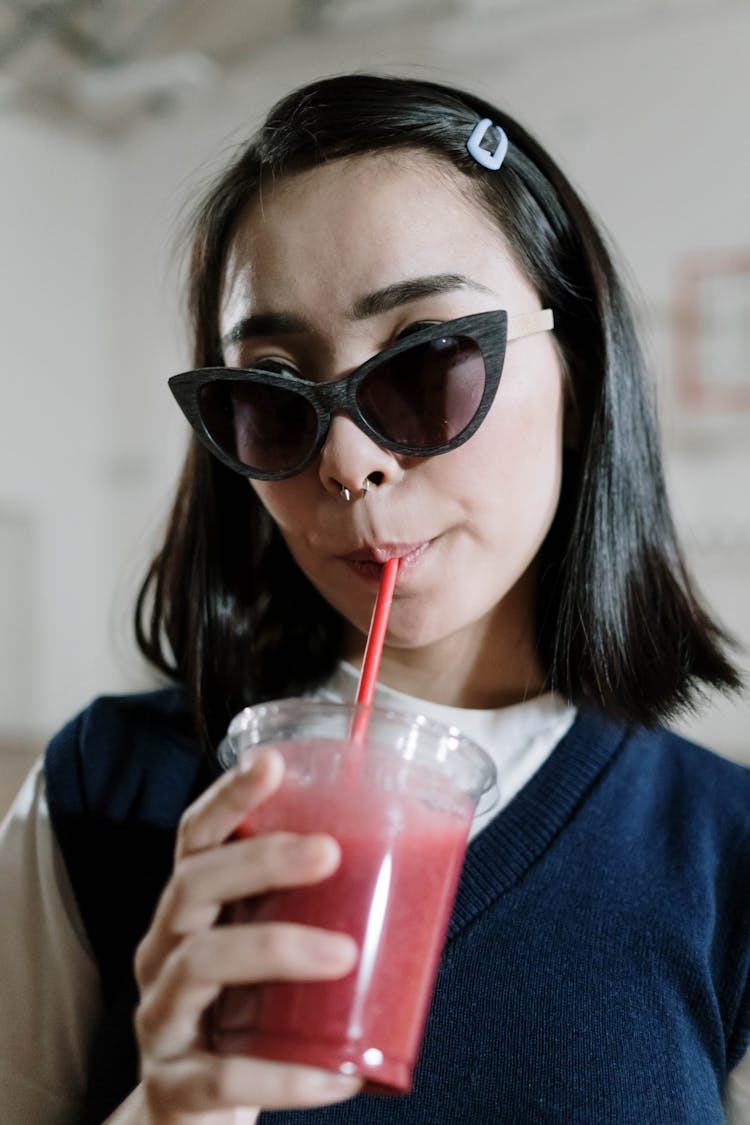 Woman In Sunglasses Drinking Shake