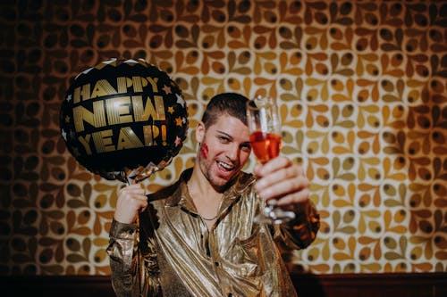 Free Man Holding Champagne Glass and Balloon Stock Photo