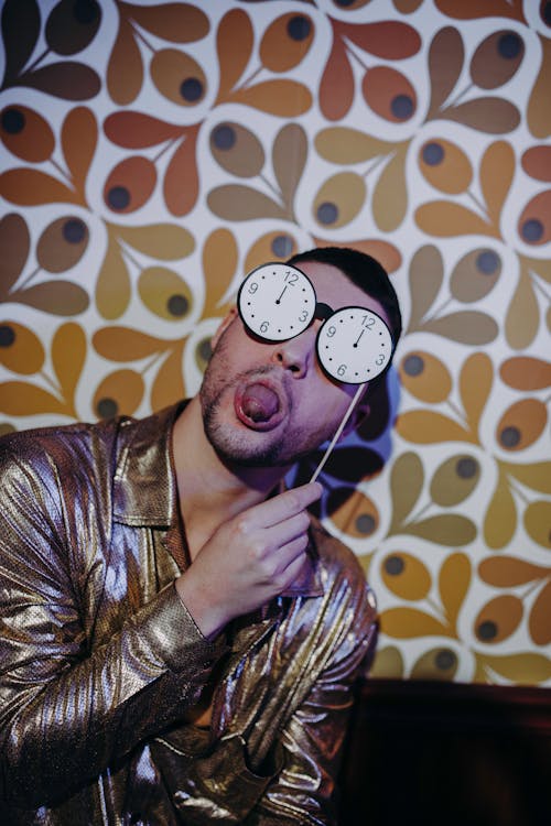 Man Sticking His Tongue Out while Holding a Clock Sunglasses