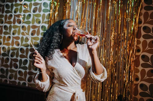 Woman in Party Dress Drinking Champagne