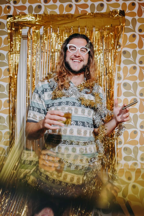 Photo of a Man with Eyeglasses Holding a Glass