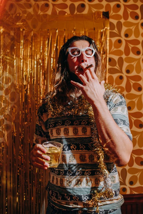 Woman Smoking Cigar While Holding a Glass