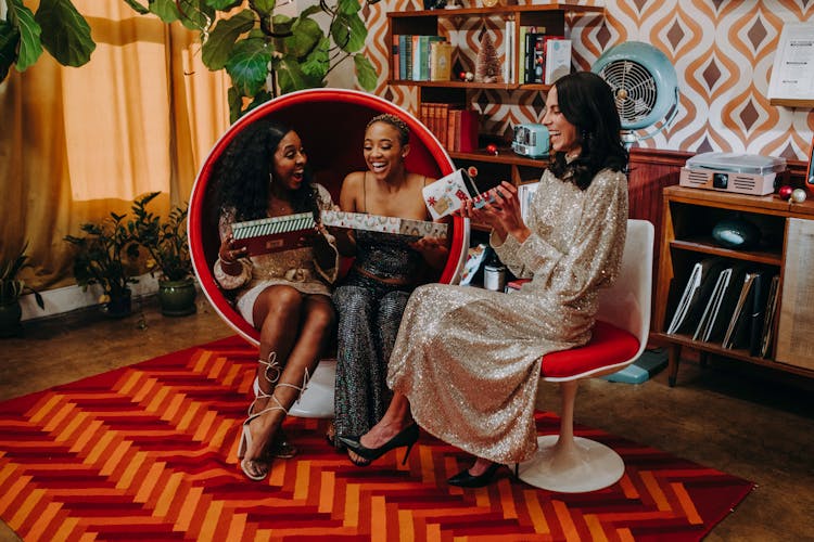 Photo Of Women Opening Gifts Together