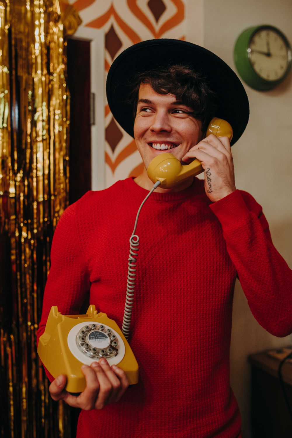 Man Using Red Telephone Man in Red Sweater Holding a Telephone · Free Stock Photo
