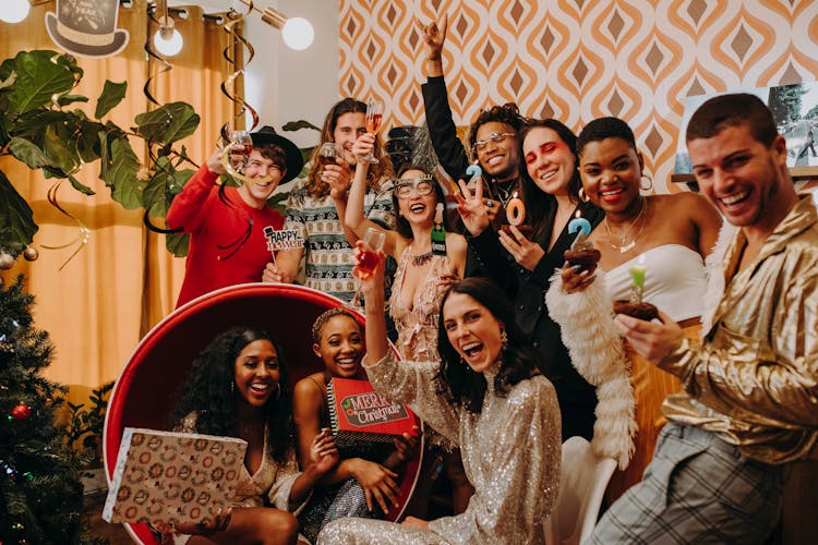 Men And Women Holding Wine Glasses In A Party