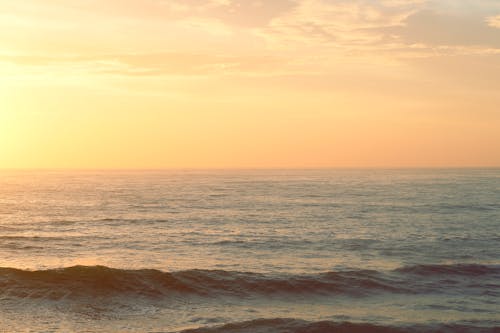 Free Ocean Waves at Sunset Stock Photo