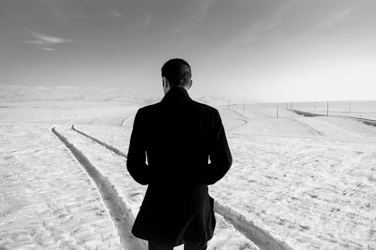 Unrecognizable Man In Snowy Field