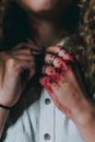 Crop woman with hand in blood