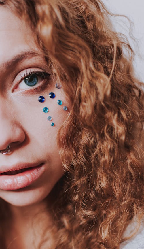 Crop woman with piercing looking at camera