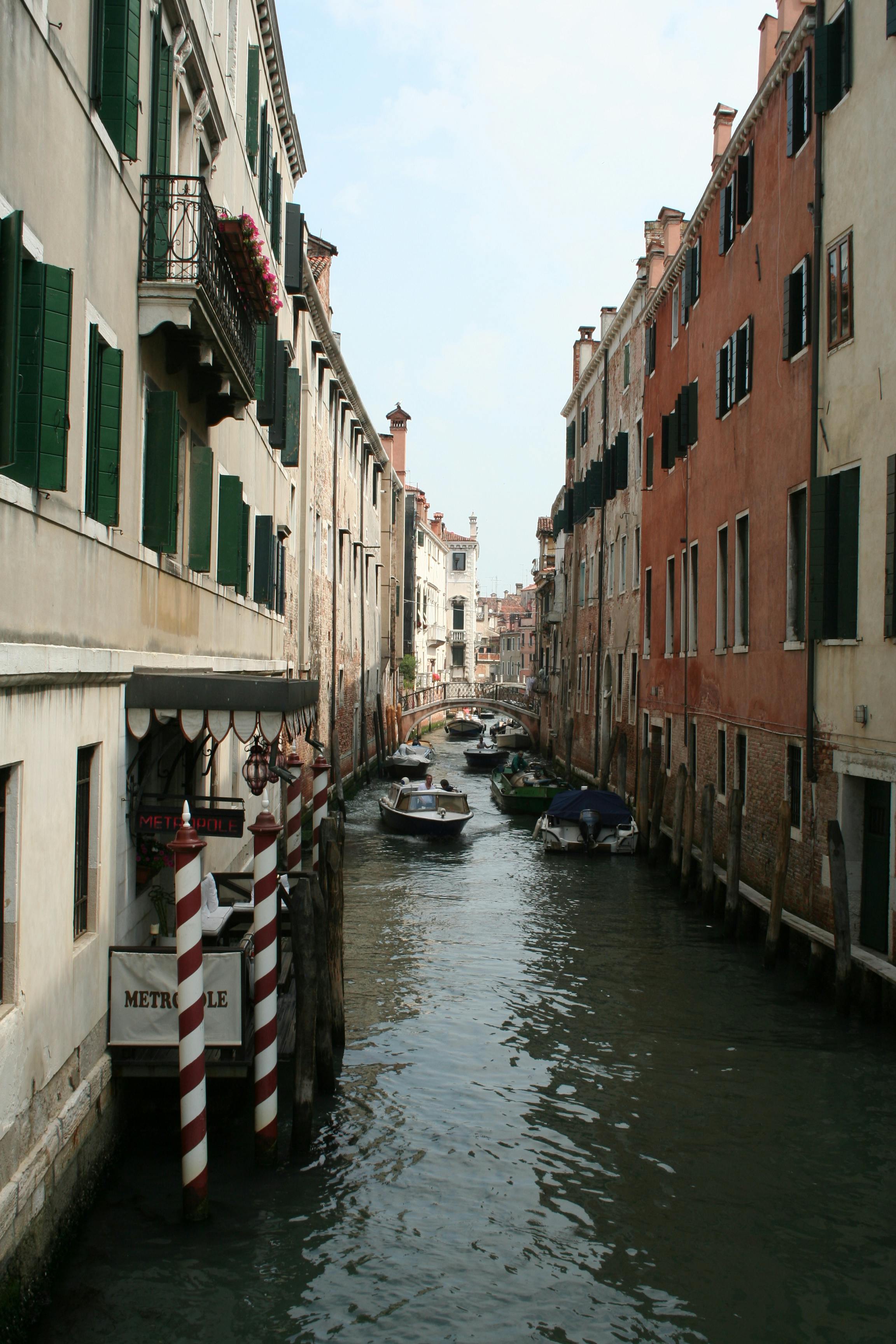 boats sailing through canal in venice italy