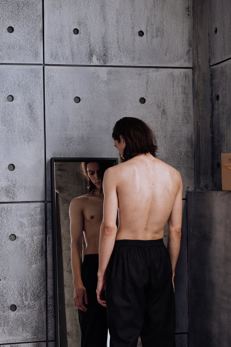 Shirtless Man Standing In Front Of A Mirror 