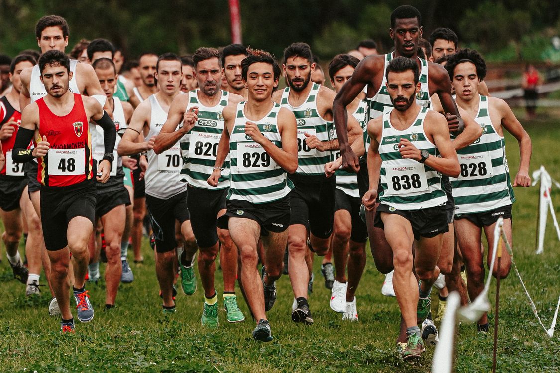 Men Running Group Group of Men Running on a Grassy Field · Free Stock Photo