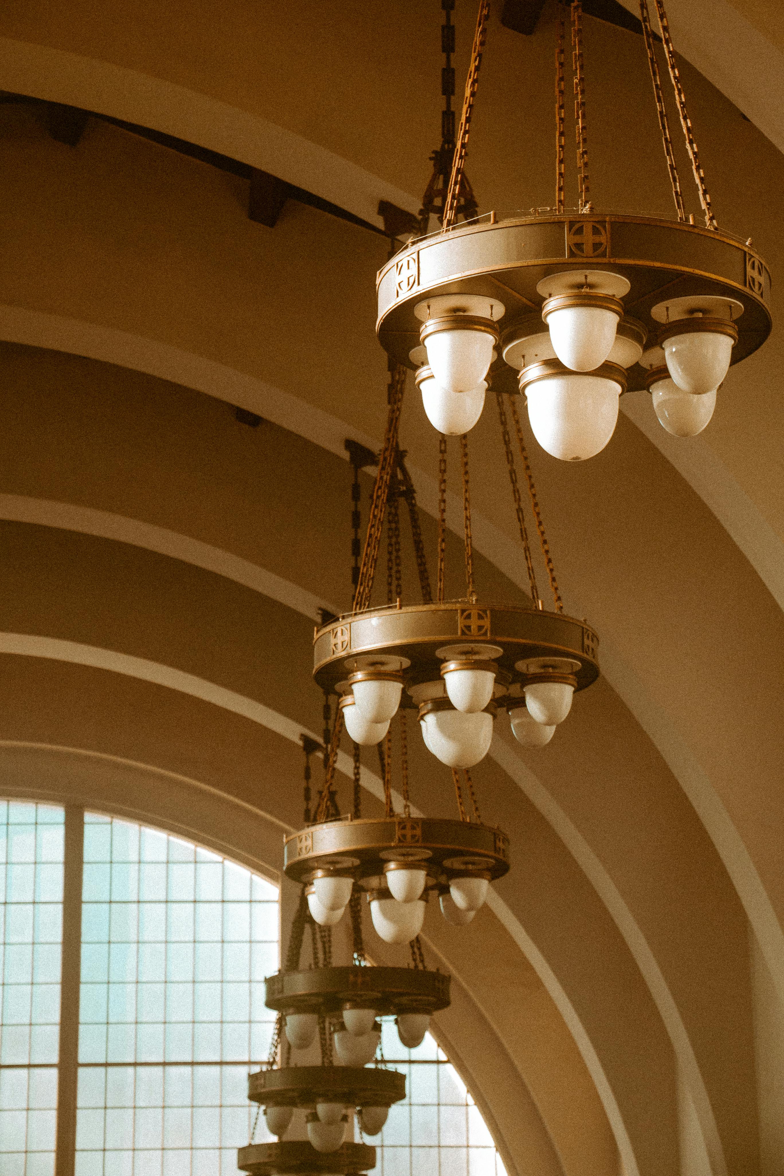 Beautiful vintage chandeliers hanging in a historic San Diego building, showcasing elegant architectural design.