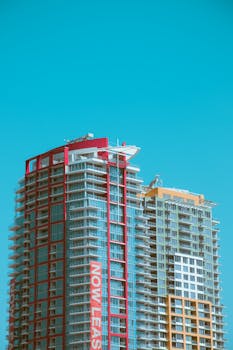 Two high-rise buildings against a clear blue sky in San Diego.