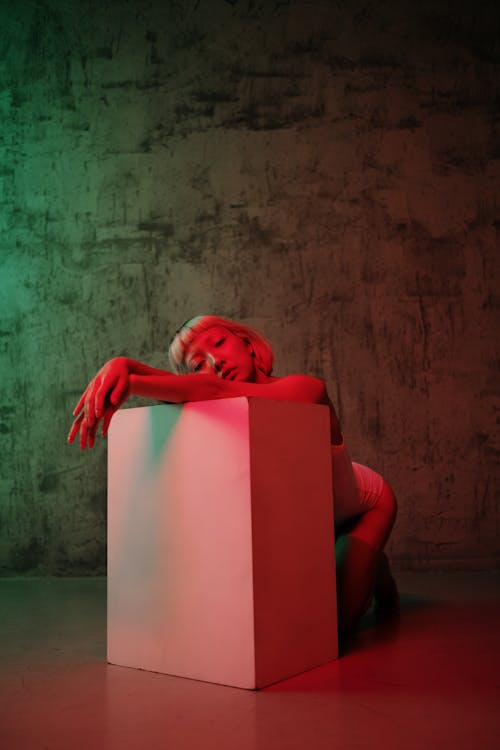 Free Young Woman Leaning on the White Block Stock Photo