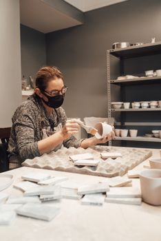 Artist preparing pottery in studio