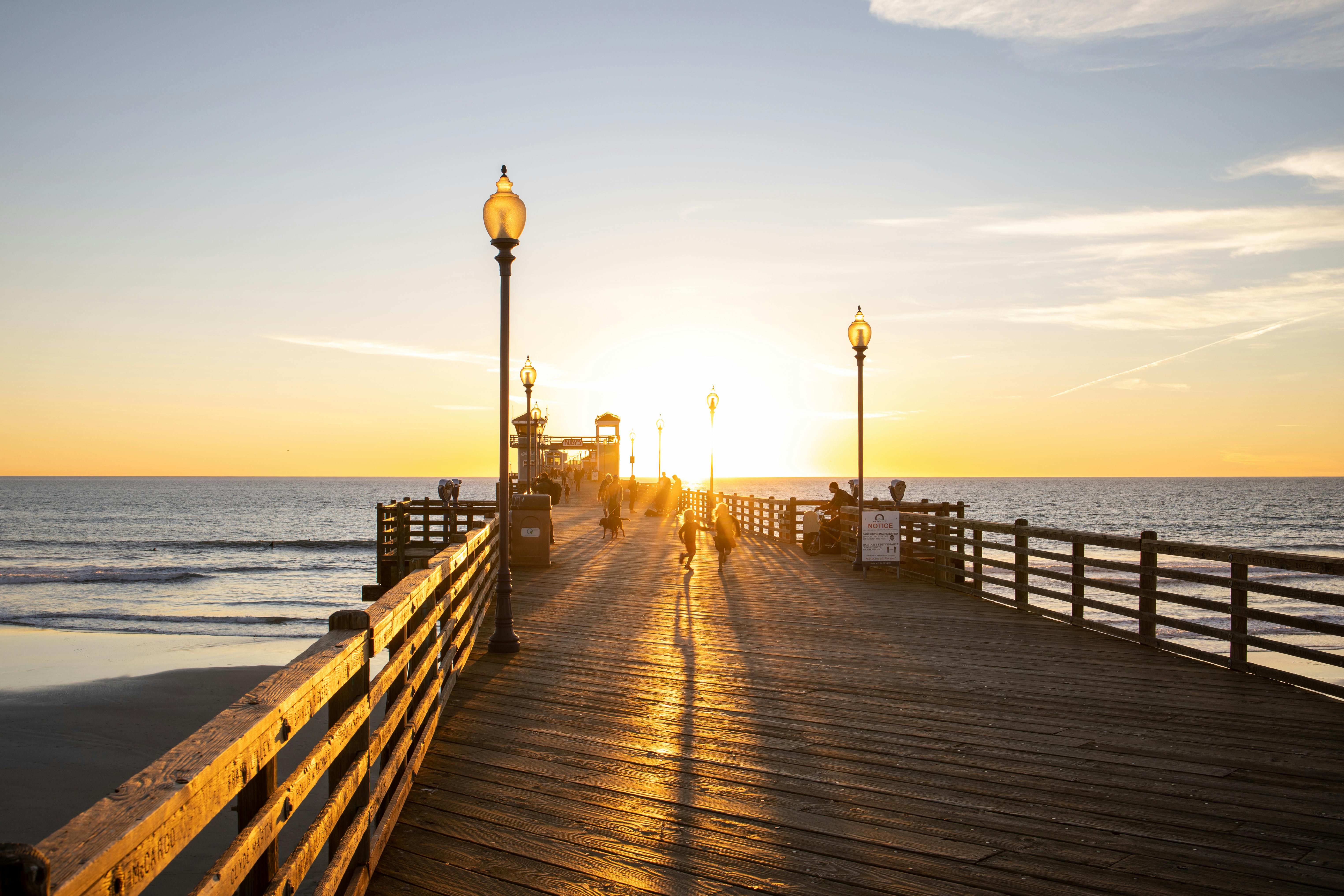 A serene sunset view at Oceanside Pier, capturing the golden horizon and silhouettes.