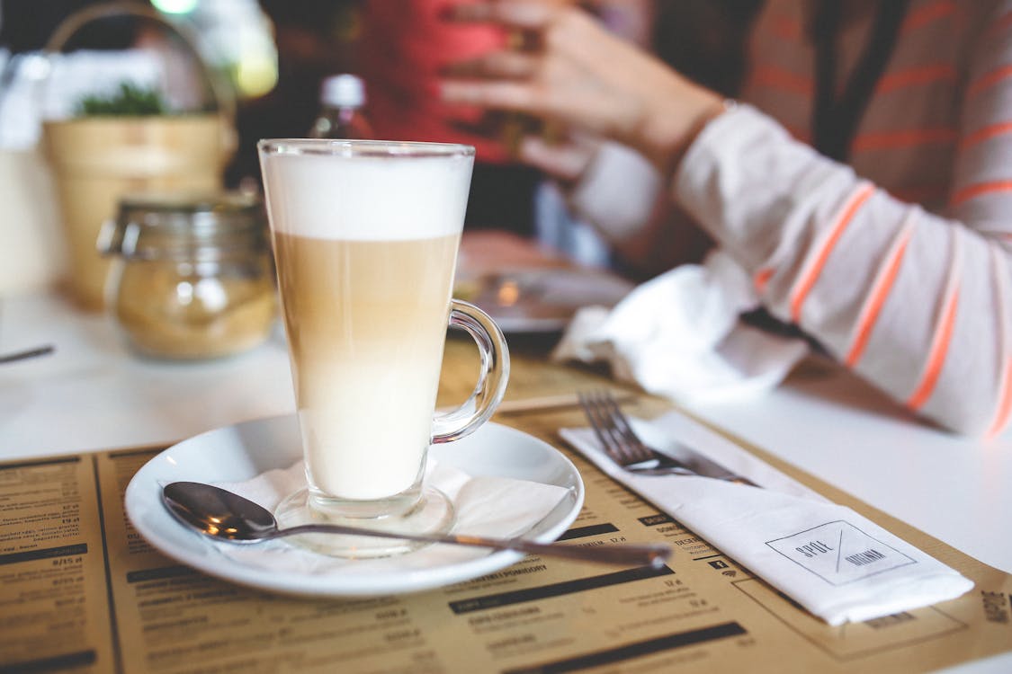 Free Coffee Latte with Frothy Milk in Tall Glass Stock Photo
