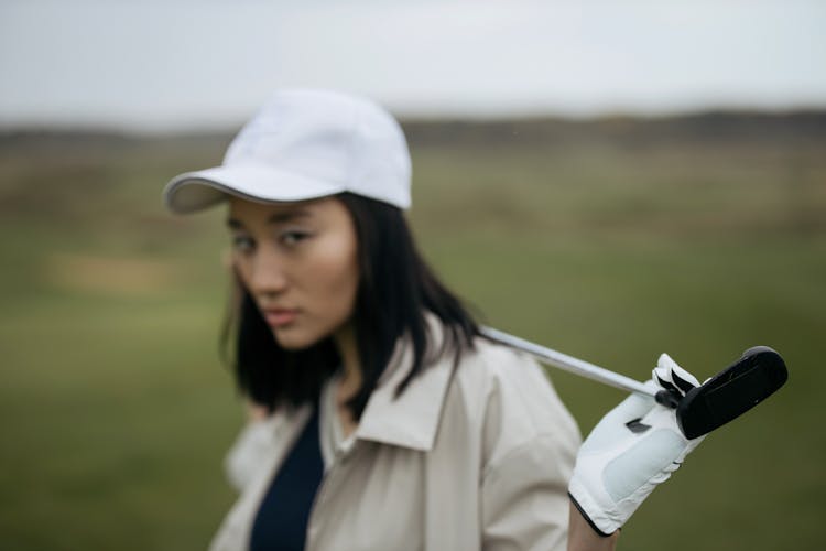 Woman In White Cap With Golf Club