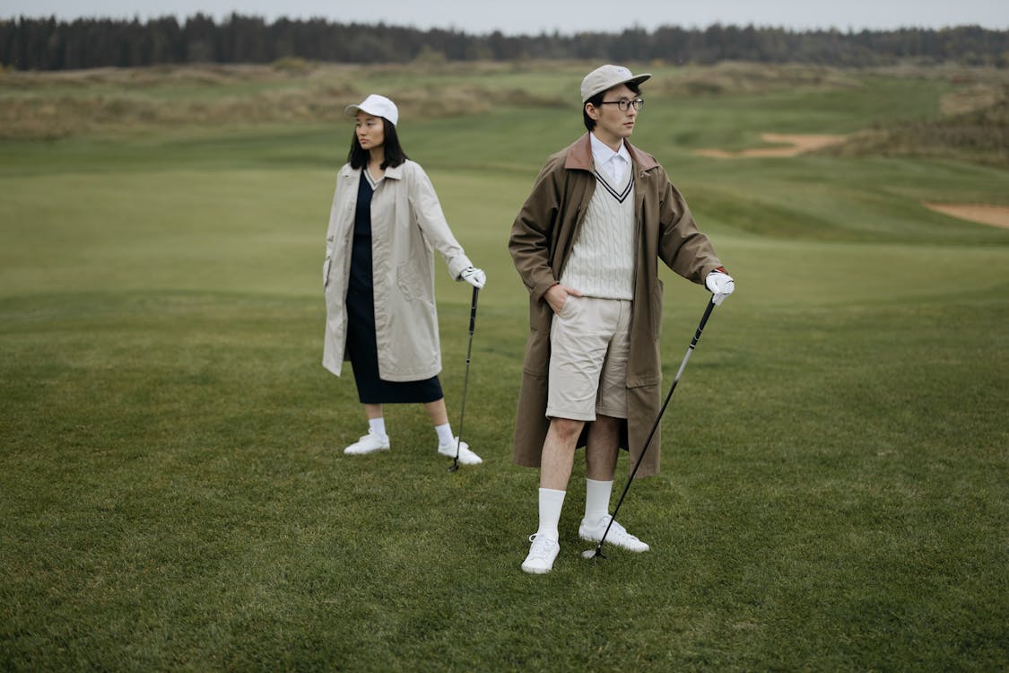 Free Man and Woman with Golf Clubs on Golf Course Stock Photo