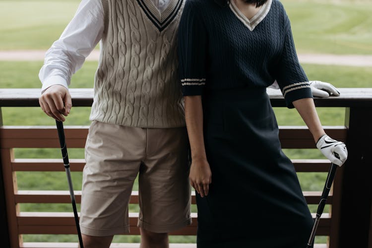 Man And Woman In Golf Attire