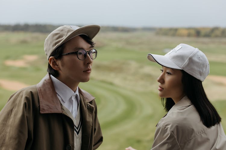 Man And A Woman Wearing Caps