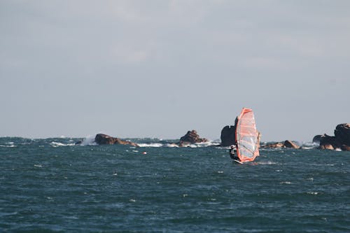 Man Windsurfing on a Blue Sea