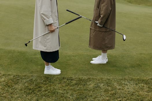 Person in Brown Coat Holding Black Stick