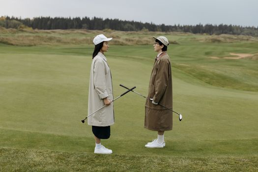 Man in White Robe Holding Stick Standing on Green Grass Field