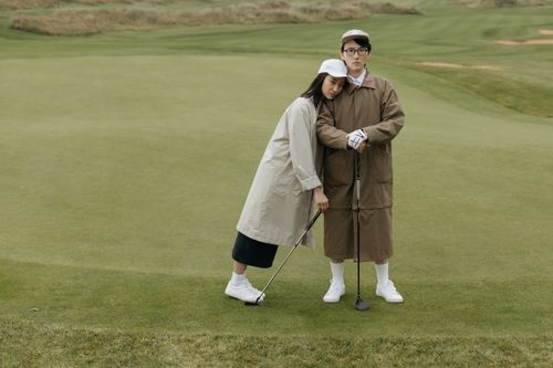 Free Couple enjoying golf together in casual attire. Perfect for leisure and sports themes. Stock Photo