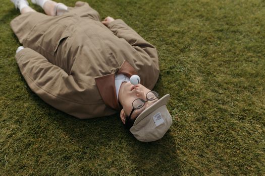 Man in Brown Dress Shirt Lying on Green Grass Field