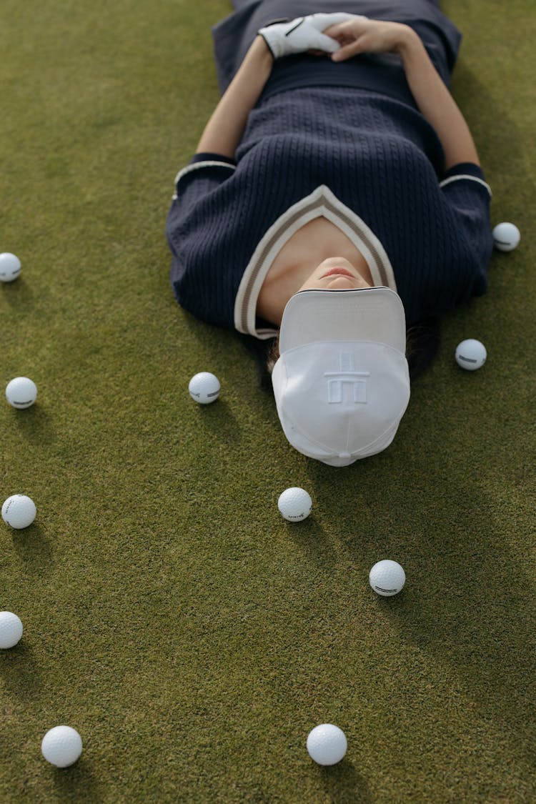 A Woman Golfer Lying On Grass